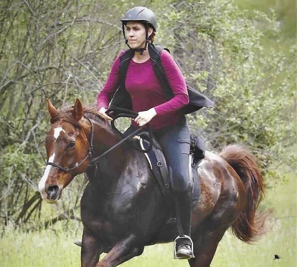 Woman conditioning an Arabian endurance horse riding in a Freeform treeless saddle.